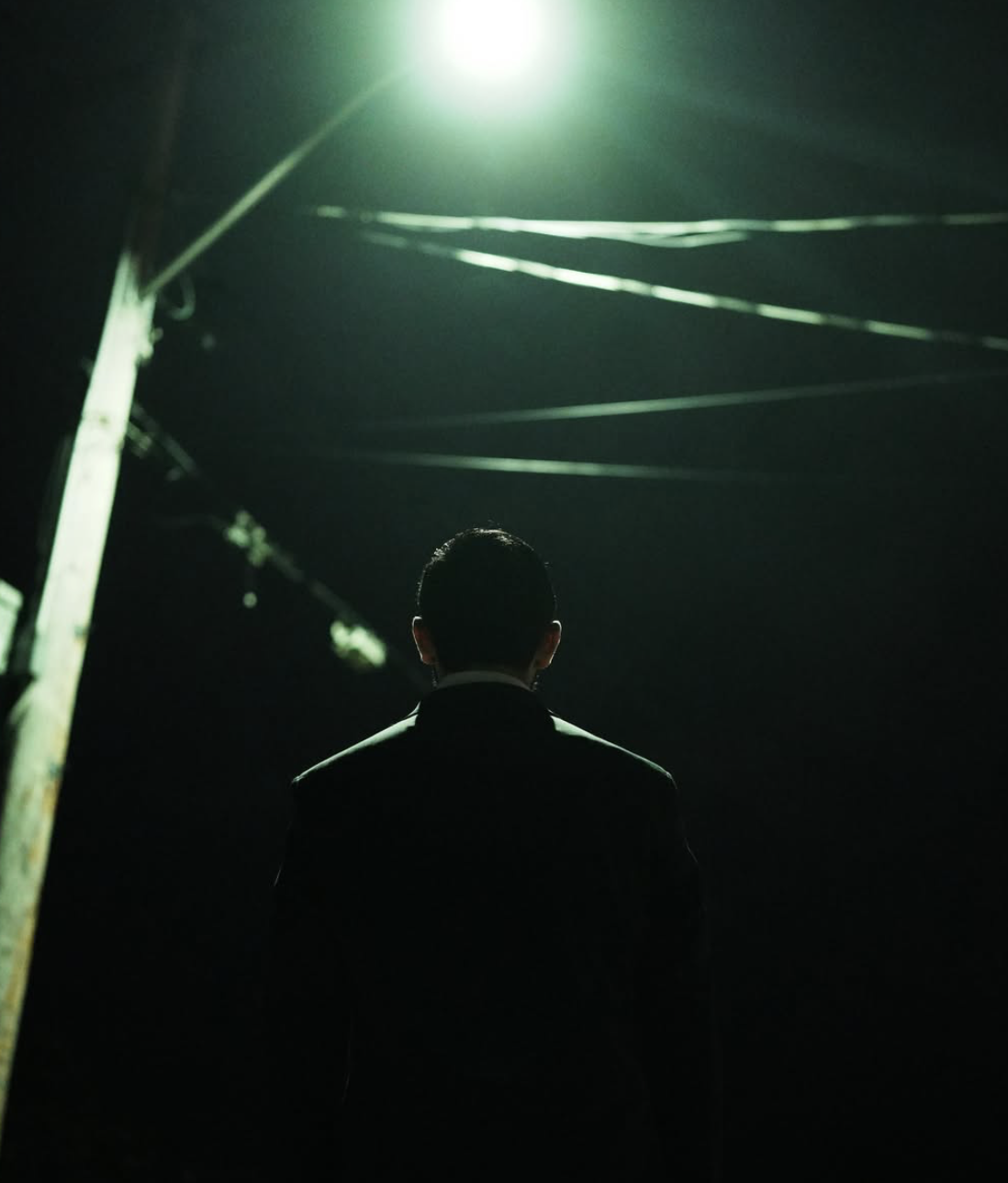 A figure under a spotlight